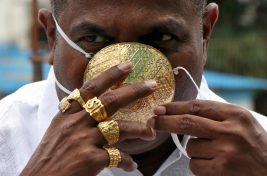 Shankar Kurhade (48), wears his face mask made out of gold as he poses for a photograph amidst the spread of the coronavirus disease (COVID-19) in Pune, India, July 4, 2020. Kurhade claims the mask weighs 50 grams and costs around $3870. REUTERS/Stringer NO ARCHIVES. NO RESALES.     TPX IMAGES OF THE DAY